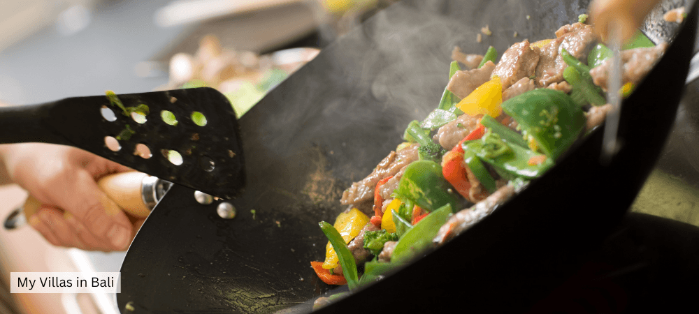 Bali chef cooks food in a wok