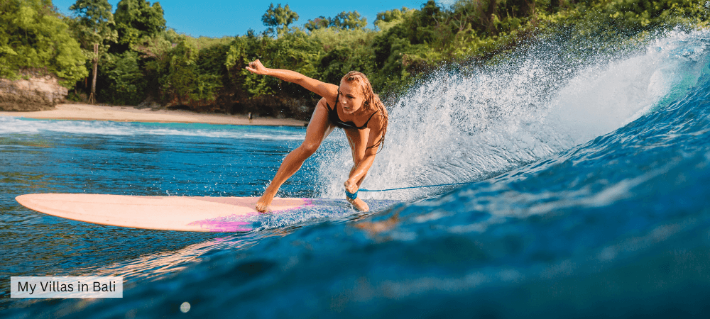teen girl surfing in bali