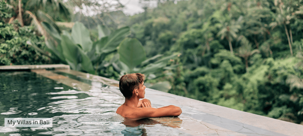 teenage boy looking at a lush bali forest
